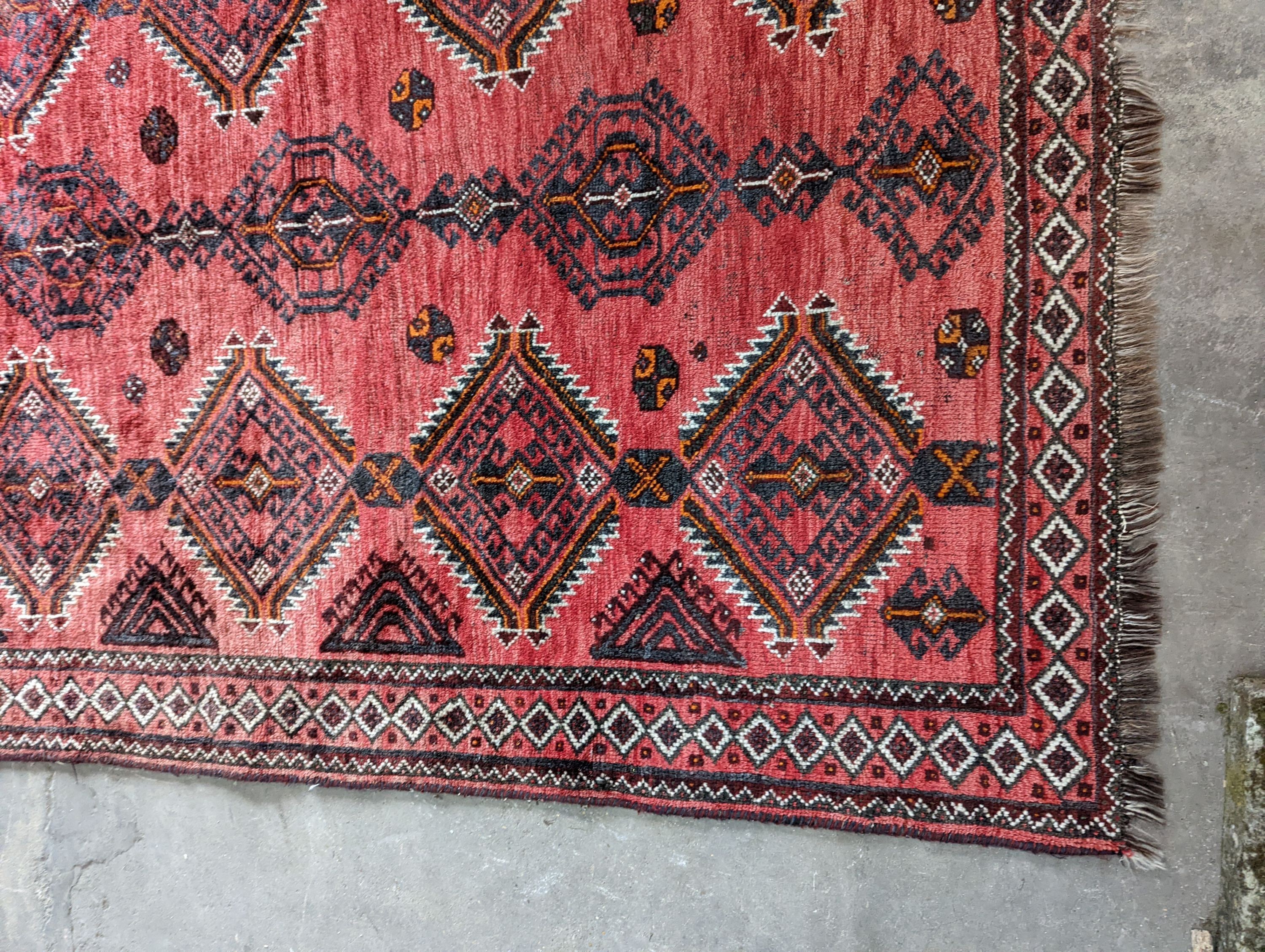 A Caucasian style red ground rug, 255 x 167cm